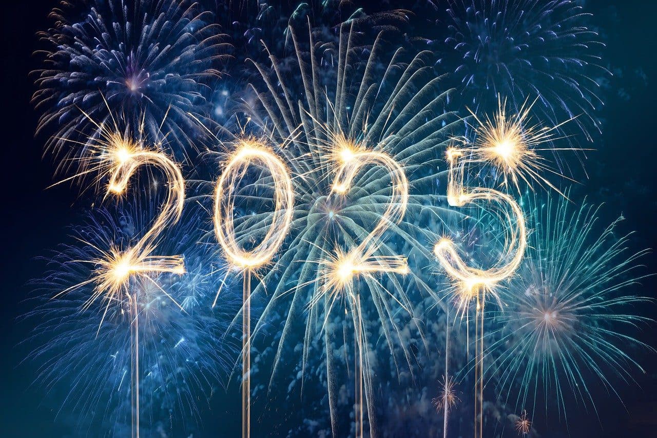 Sparklers forming "2025" with fireworks background