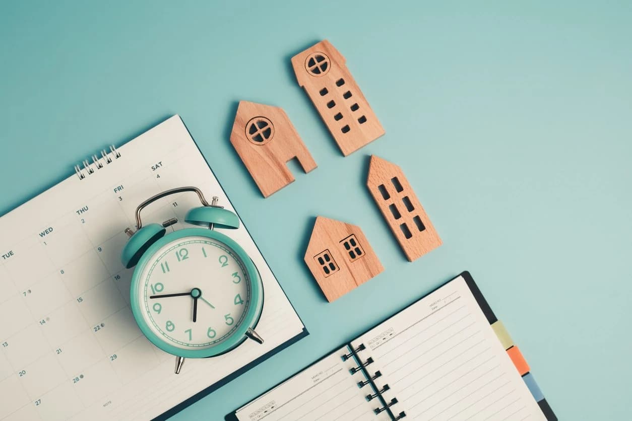 Property clock concept with calendar, clock and model houses for Australian market cycle analysis