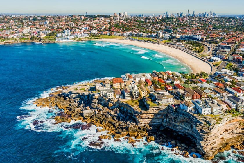 Coastal city view with beach and rocky cliffs