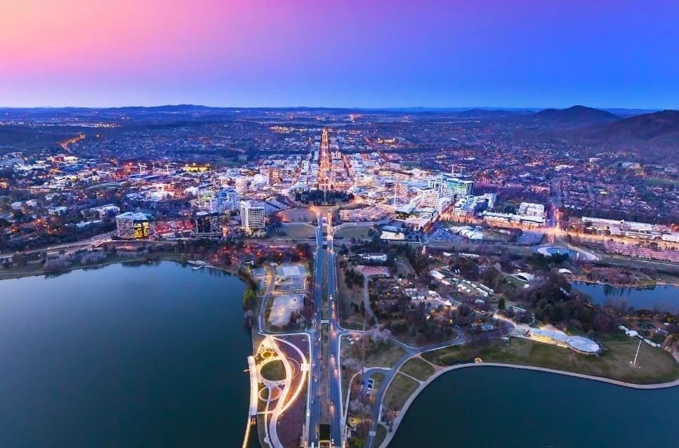 Aerial view of a city with a lake at dusk