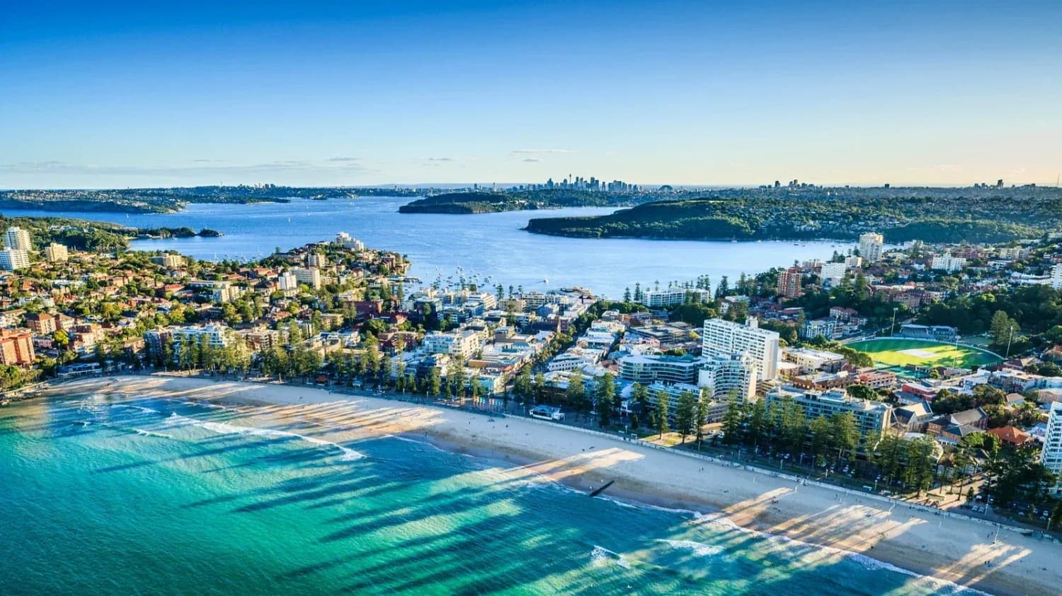 Coastal city skyline with beach and blue water