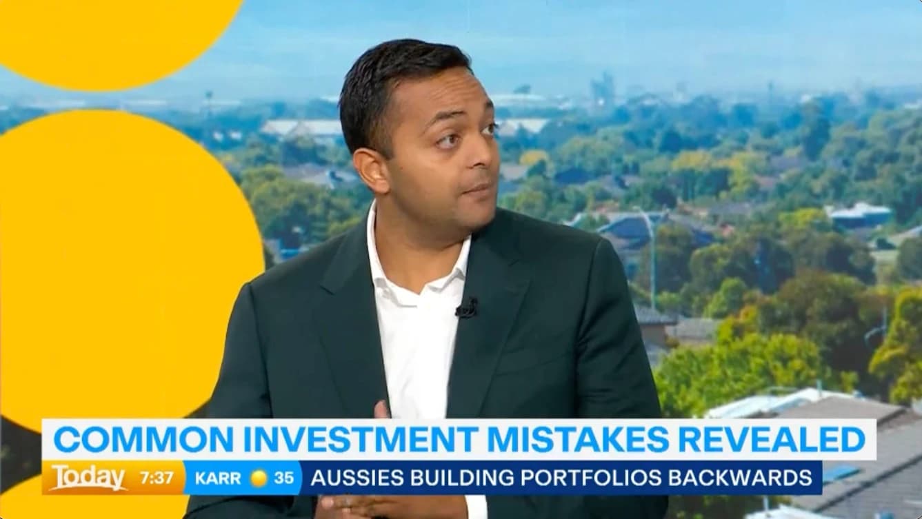 Man in suit during news broadcast with text overlay