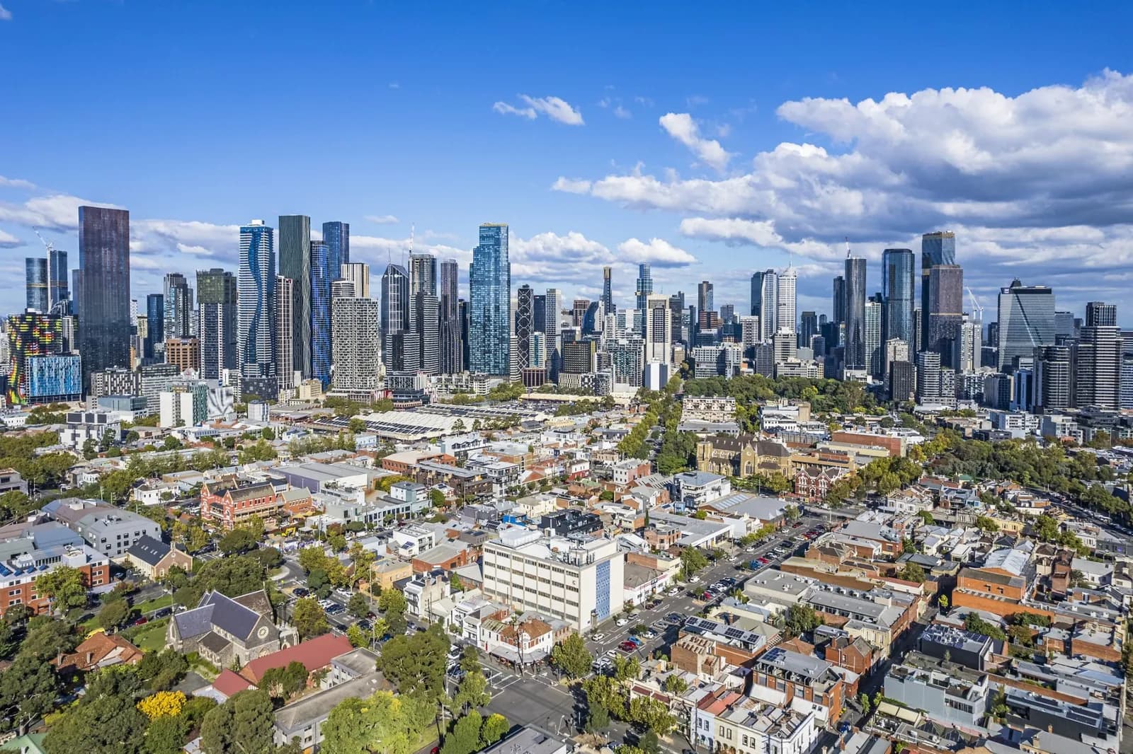 City skyline with skyscrapers and suburban houses.