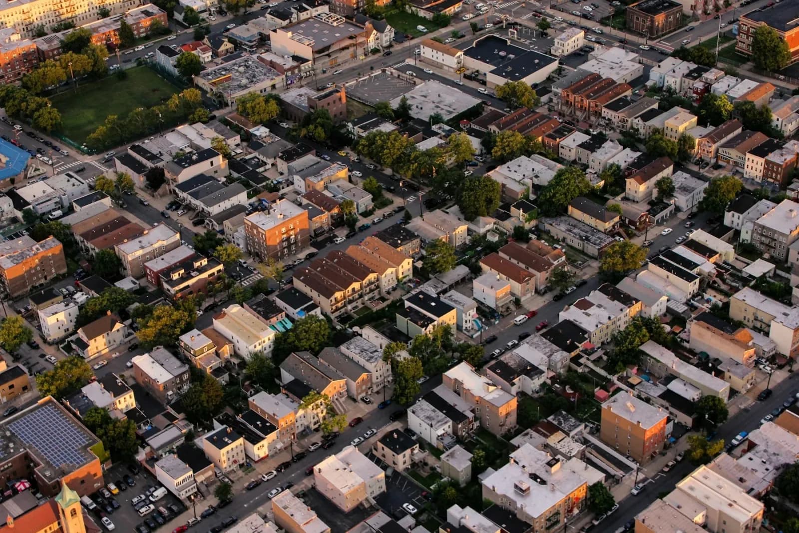 Aerial view of dense urban housing and streets.