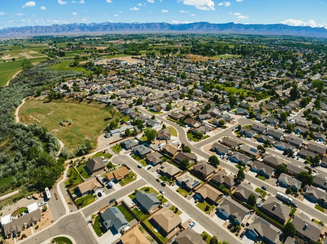 Aerial view of suburban homes with mountains in distance
