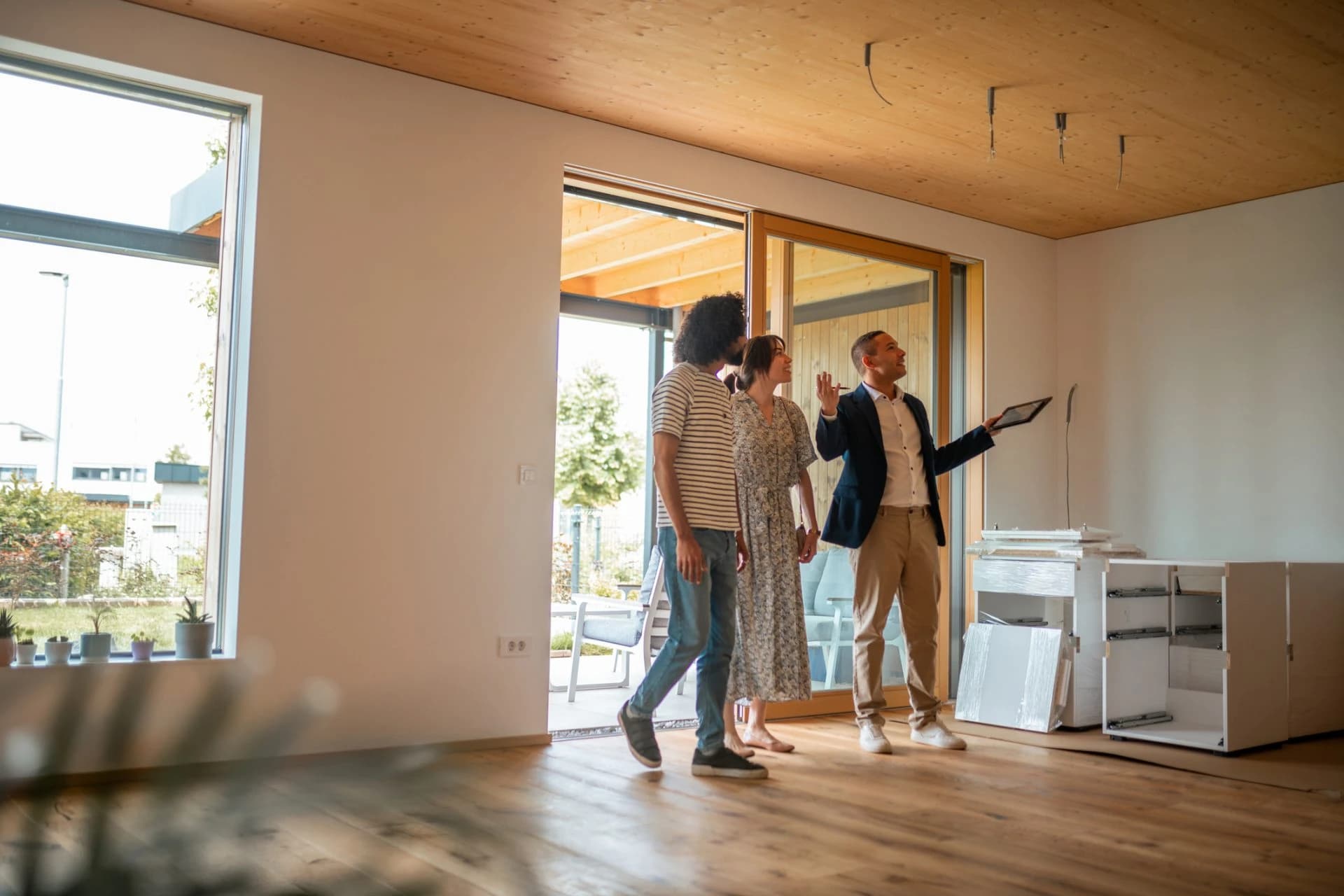 Property buyers inspecting a bright home with a real estate agent
