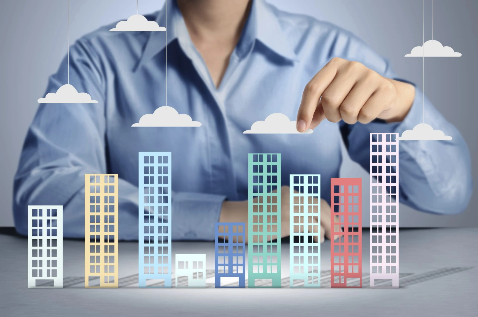 Infographic of buildings as bar chart with clouds.