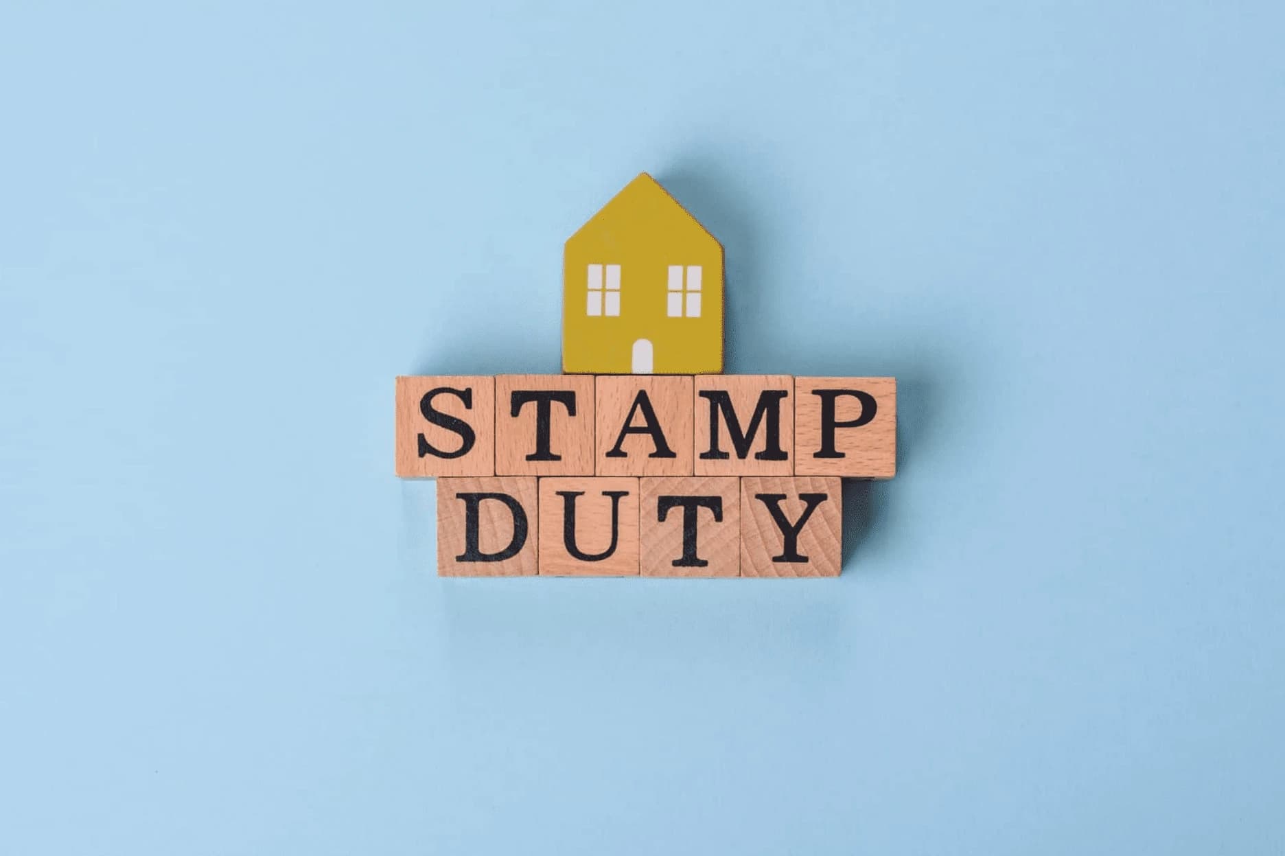 Stamp duty on wooden blocks with a house.