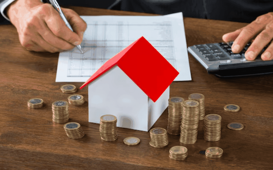 Model house, calculator, coins and a home buying checklist