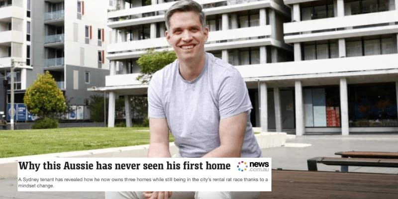 Man sitting outside modern apartment buildings
